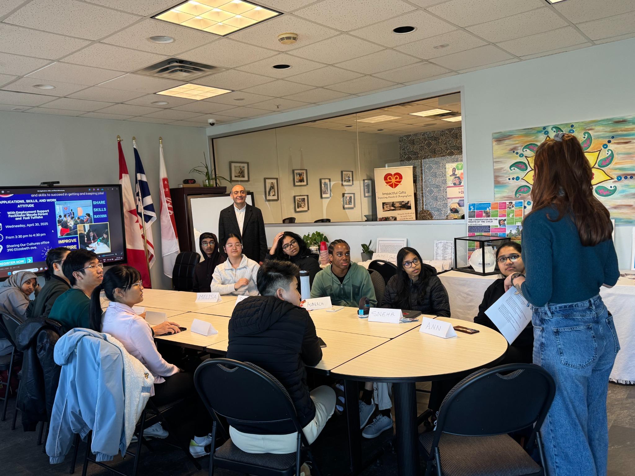 Facilitator presenting resume tips to youth group