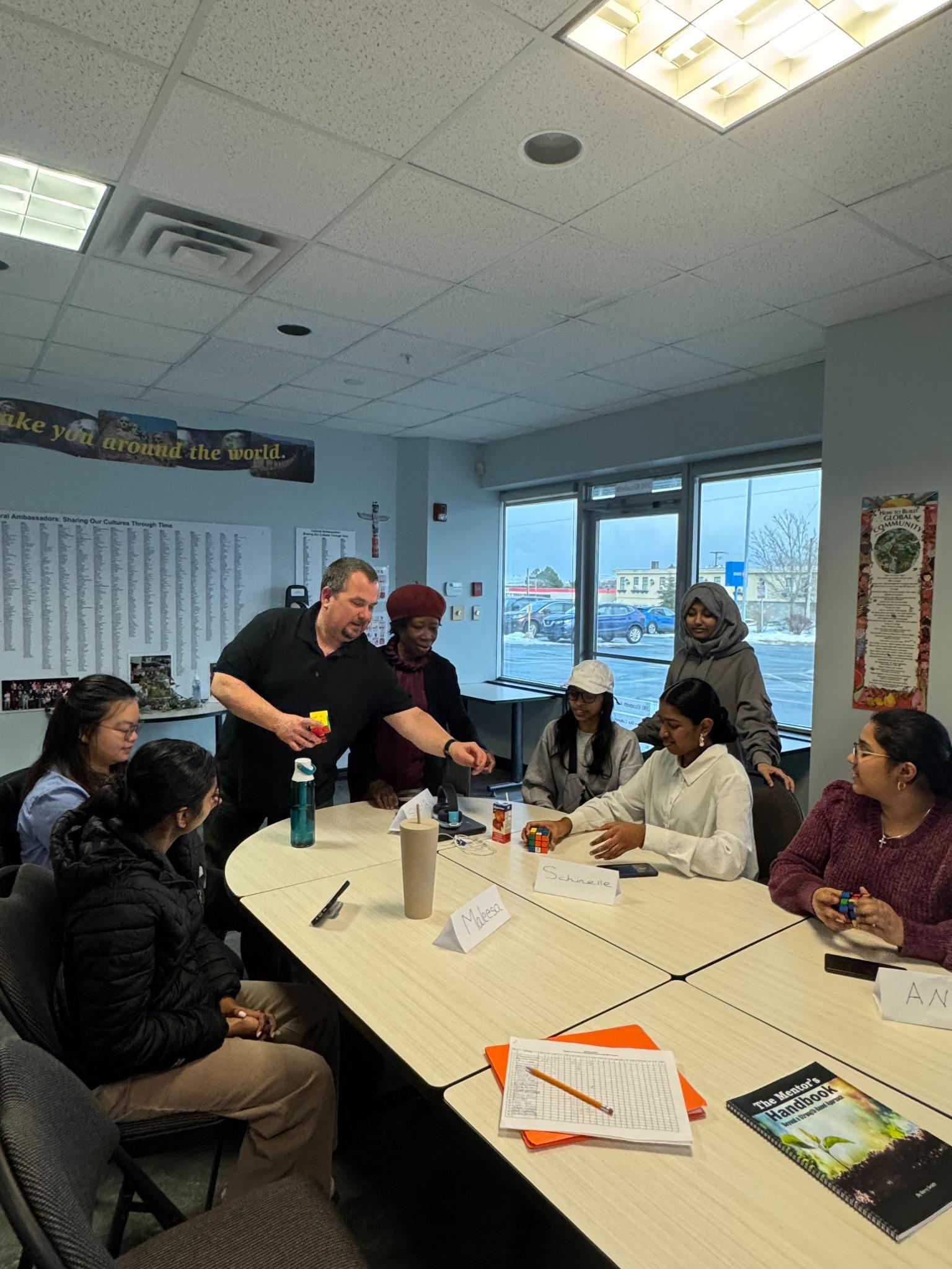 Youth interacting and problem-solving with rubik cubes