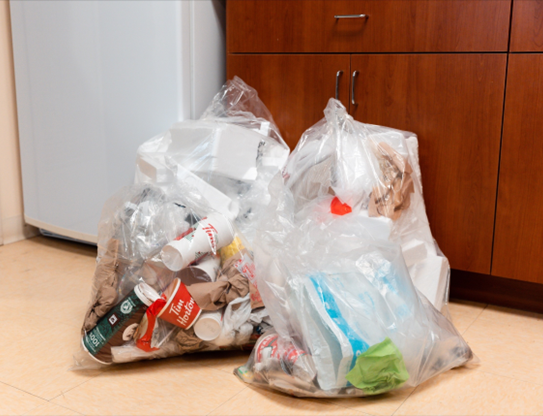 Clear plastic garbage bags showing mixed waste
